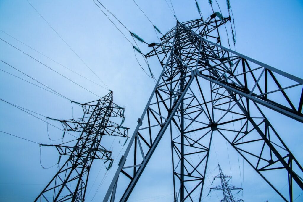 Electricity pylons on blue sky background. Power and energy. Energy conservation
